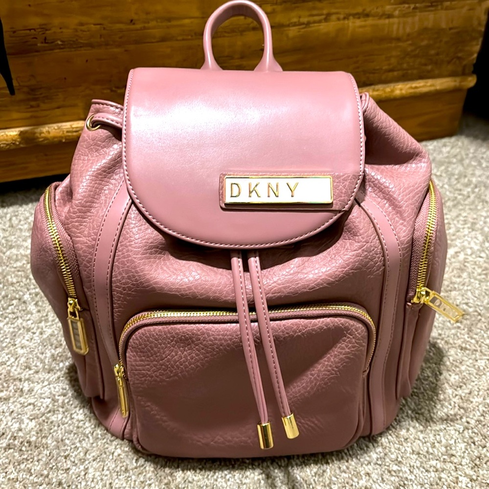 DKNY light pink backpack. All zippers work properly and straps adjust.